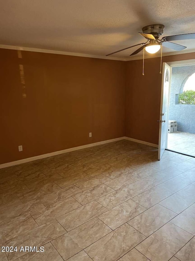 spare room featuring ceiling fan, ornamental molding, and a textured ceiling