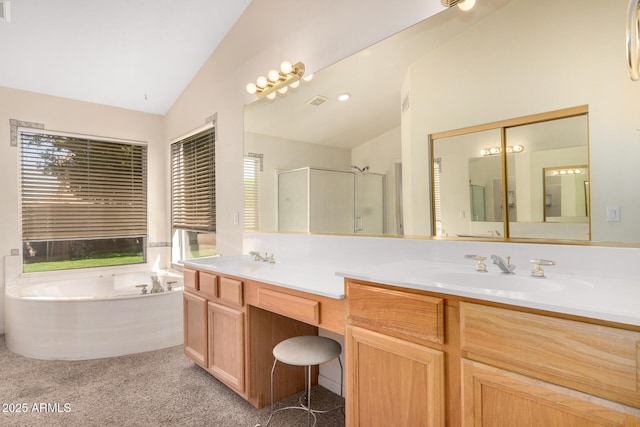 bathroom with a garden tub, a stall shower, a sink, double vanity, and vaulted ceiling