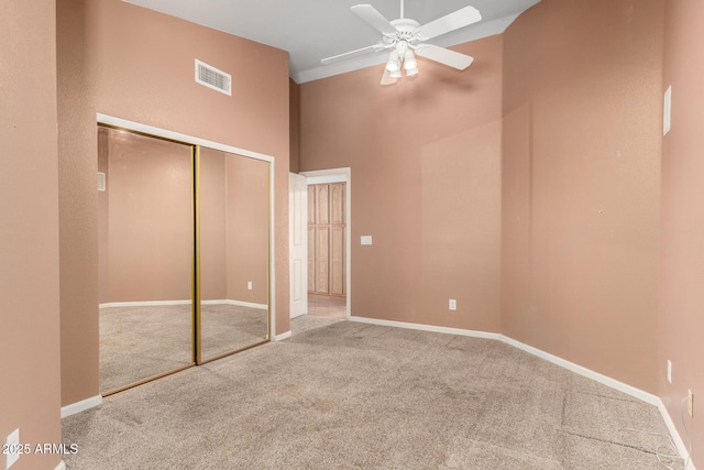 unfurnished bedroom with carpet flooring, baseboards, visible vents, and a closet