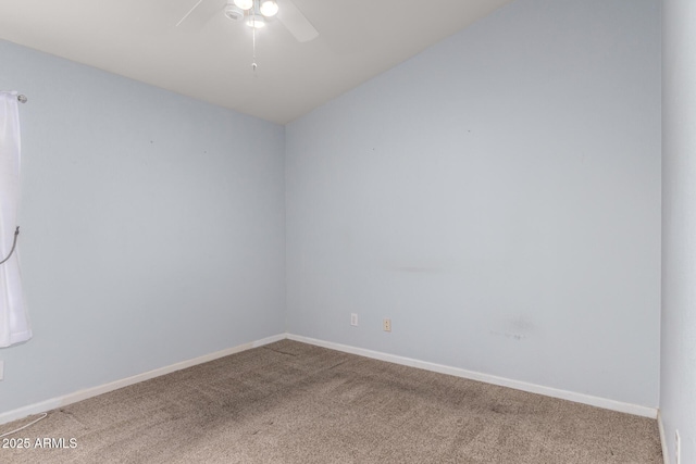 carpeted spare room with baseboards and a ceiling fan