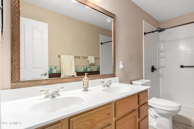 full bathroom featuring a sink, a shower, toilet, and double vanity