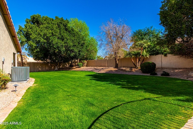 view of yard featuring central AC unit and a fenced backyard