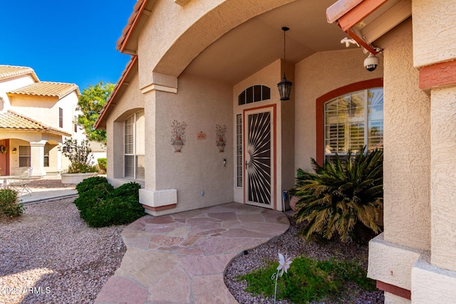 entrance to property featuring stucco siding