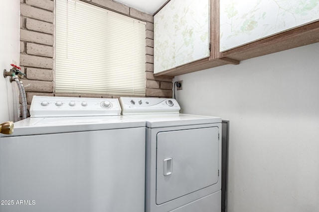 washroom featuring washing machine and dryer and cabinet space