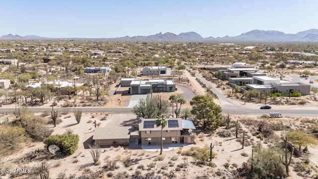 drone / aerial view with view of desert and a mountain view