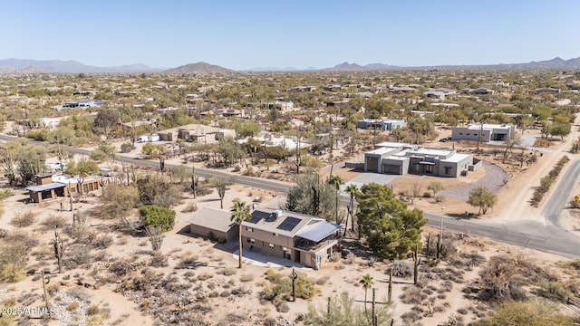 drone / aerial view featuring a mountain view and view of desert