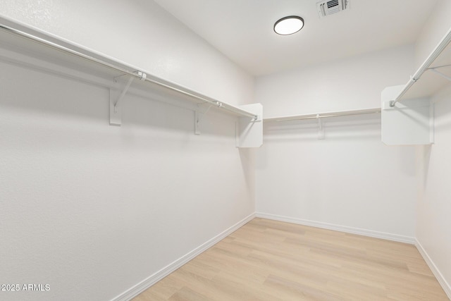 spacious closet with light wood finished floors and visible vents