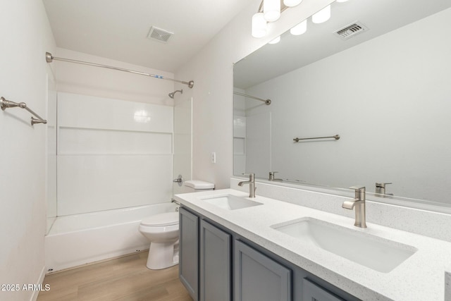 full bath featuring toilet, visible vents, and a sink