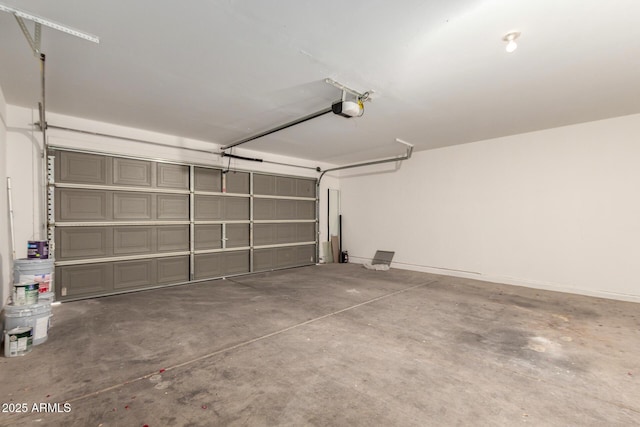 garage with a garage door opener and baseboards