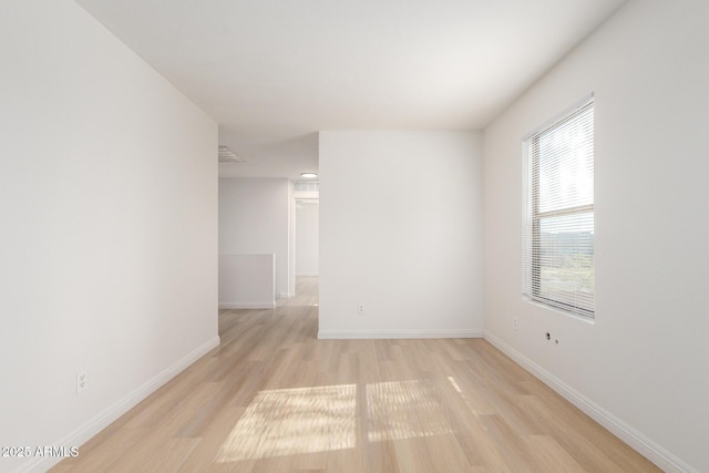 empty room featuring light wood-style flooring and baseboards