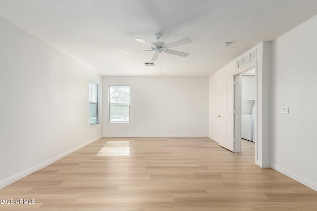 unfurnished room featuring baseboards, visible vents, and light wood-style floors