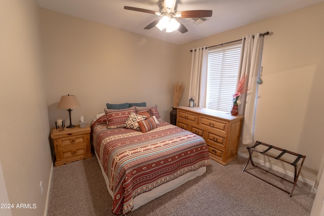 bedroom with ceiling fan and light colored carpet