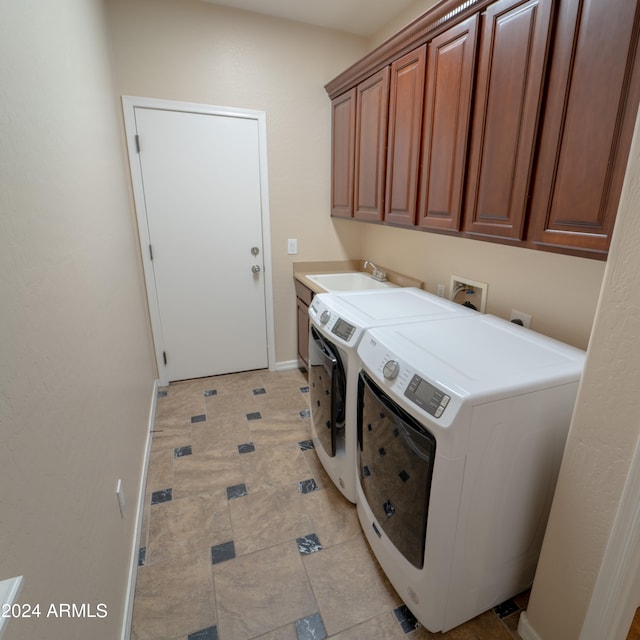 laundry room with cabinets, independent washer and dryer, light tile patterned floors, and sink