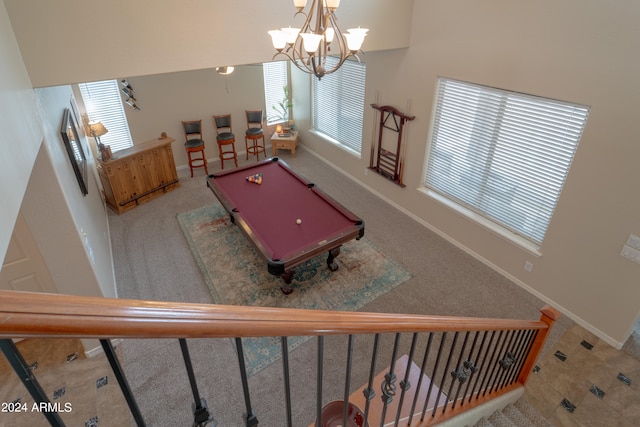 interior space featuring carpet floors, billiards, and a chandelier