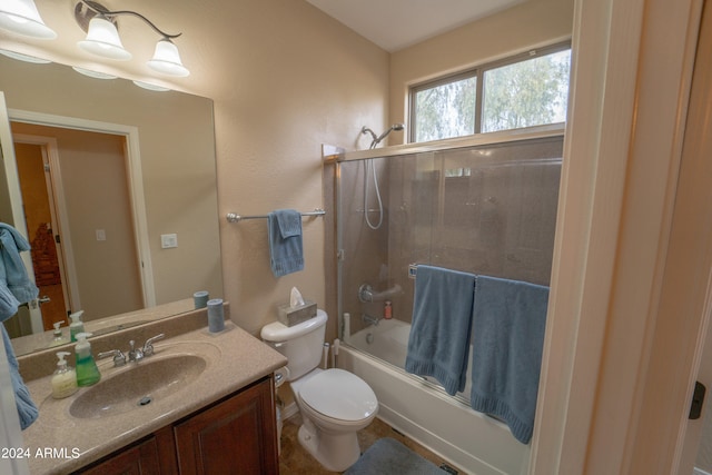 full bathroom featuring shower / bath combination with glass door, vanity, and toilet