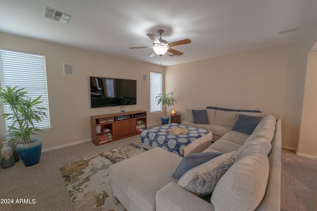 living room with carpet, ceiling fan, and a healthy amount of sunlight