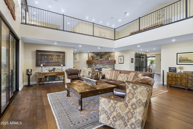36389 N 105th Pl, Scottsdale, AZ 85262 - living area with a towering ceiling, dark wood-style flooring, baseboards, a stone fireplace, and recessed lighting