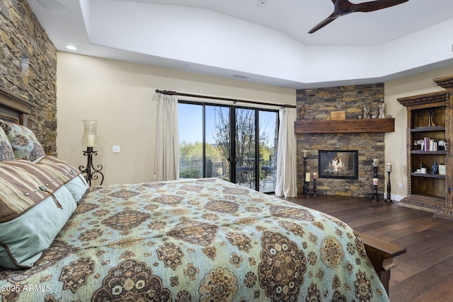 36389 N 105th Pl, Scottsdale, AZ 85262 - bedroom with a fireplace, wood finished floors, access to outside, and a ceiling fan