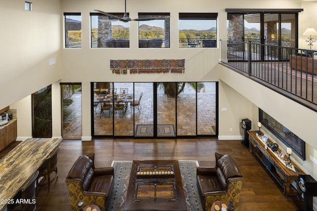36389 N 105th Pl, Scottsdale, AZ 85262 - dining space with hardwood / wood-style floors, a towering ceiling, baseboards, a ceiling fan, and a mountain view