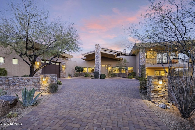 36389 N 105th Pl, Scottsdale, AZ 85262 - view of front of house featuring stucco siding, a balcony, decorative driveway, and stone siding