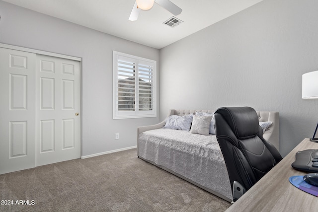 bedroom with dark colored carpet, a closet, and ceiling fan