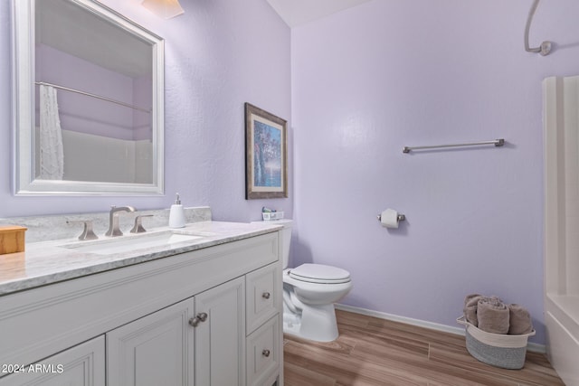 full bathroom featuring oversized vanity, toilet, shower / bath combo, and hardwood / wood-style flooring