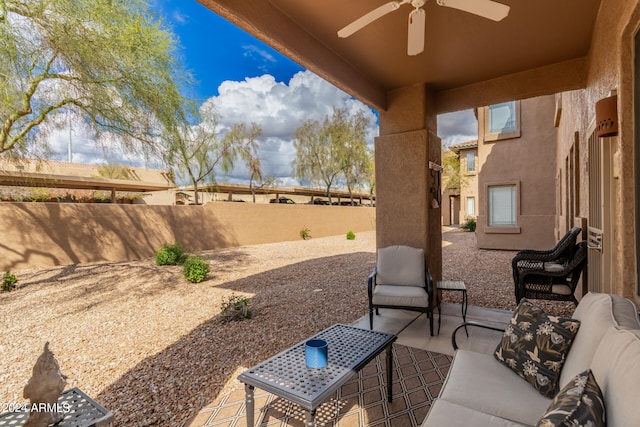 view of patio / terrace with ceiling fan and an outdoor living space