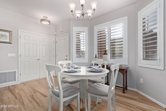 dining area featuring a chandelier and light hardwood / wood-style floors