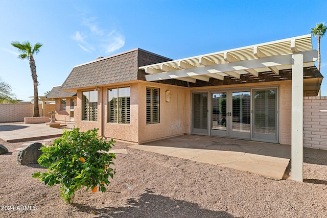 back of property with a pergola, french doors, and a patio