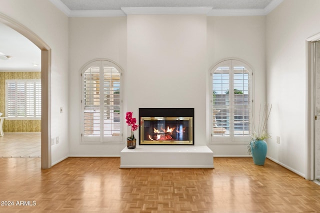 unfurnished living room featuring light parquet floors and crown molding