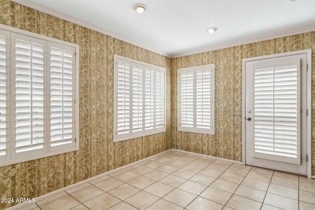 tiled spare room with ornamental molding