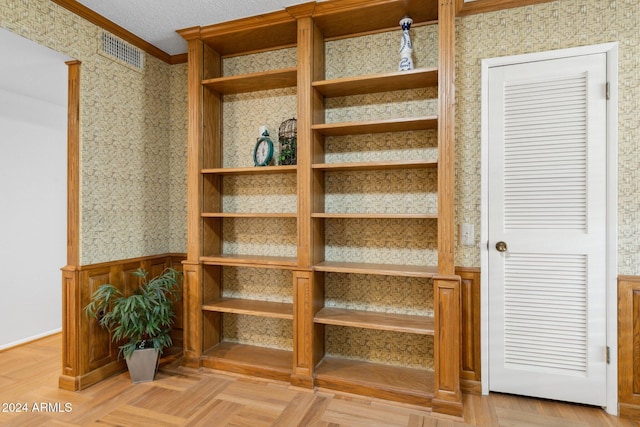 interior space featuring parquet flooring and crown molding