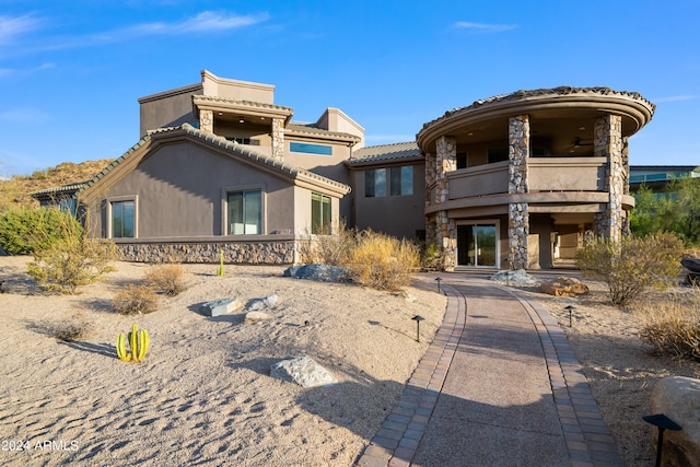 back of house featuring a balcony