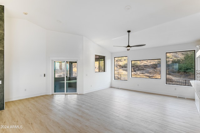 unfurnished living room featuring lofted ceiling, ceiling fan, and light hardwood / wood-style floors