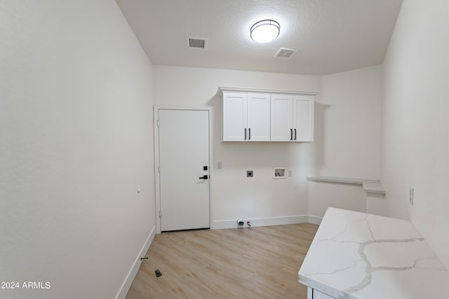 laundry room with washer hookup, light wood-type flooring, cabinets, and hookup for an electric dryer