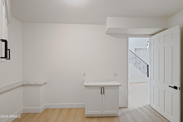 laundry room with light hardwood / wood-style flooring