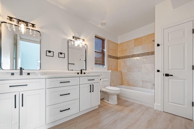 full bathroom featuring wood-type flooring, toilet, a wealth of natural light, and vanity