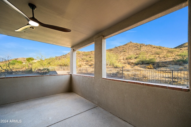 view of patio / terrace featuring a mountain view and ceiling fan