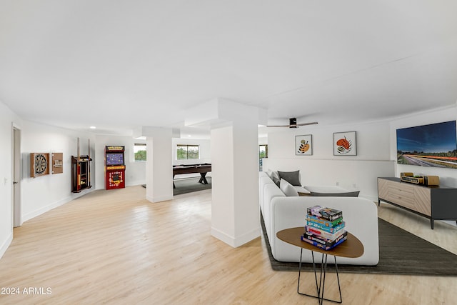 living room with ceiling fan, pool table, and light wood-type flooring