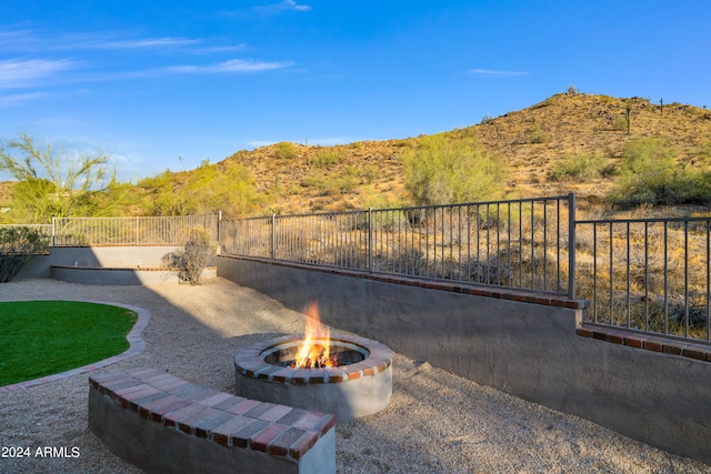 view of patio / terrace featuring a fire pit and a mountain view