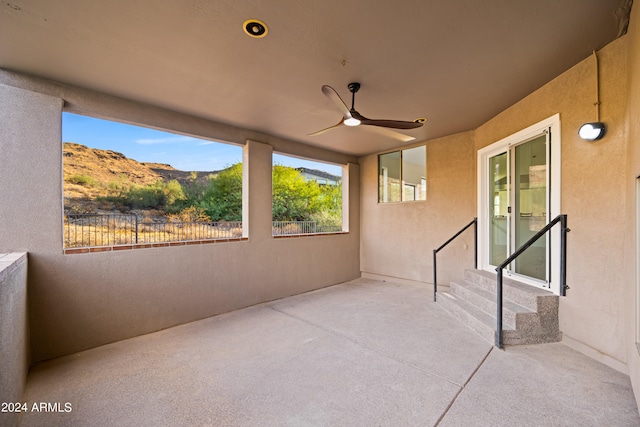 view of patio / terrace featuring ceiling fan and a mountain view