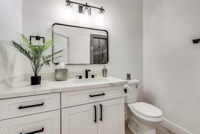 bathroom with vanity, toilet, and tile patterned floors