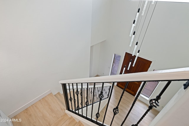 stairs with hardwood / wood-style floors