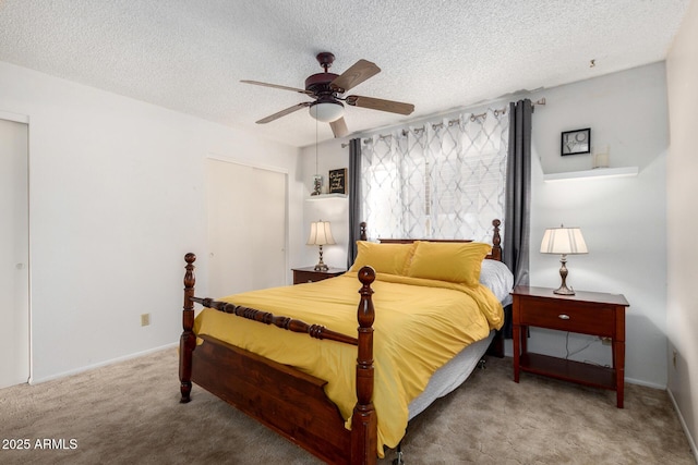 carpeted bedroom with baseboards, a textured ceiling, and ceiling fan