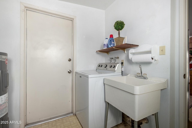 laundry area featuring a sink, washer / clothes dryer, light floors, and laundry area