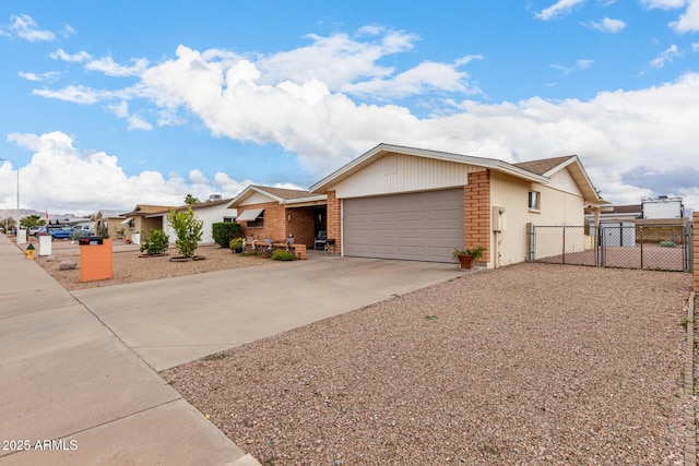 ranch-style home featuring a gate, fence, a garage, and driveway