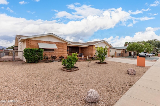 single story home with driveway, a gate, fence, an attached garage, and brick siding