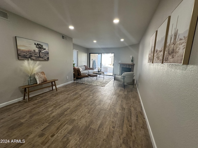 unfurnished living room with dark wood-type flooring