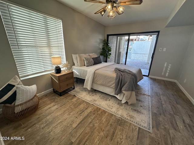 bedroom with ceiling fan, dark hardwood / wood-style flooring, and access to outside