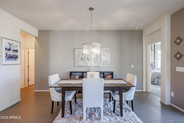 tiled dining area featuring an inviting chandelier